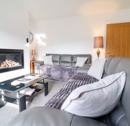 A living room with a sofa and coffee table at Arnant in Dolgellau