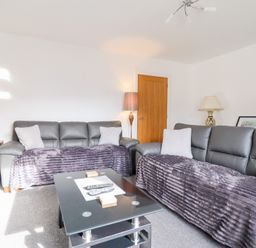 A living room with sofas and a coffee table at Arnant in Dolgellau