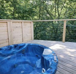 An outdoor space with a hot tub on a wooden deck at 2 Streamside in Lanreath
