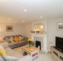 A living room with two sofas a coffee table and a television at Market House in Abbotsbury