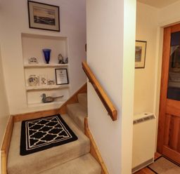 A staircase with a handrail in a hallway at Holemire Barn in Lorton