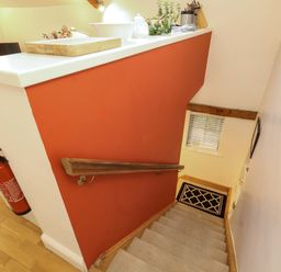 A staircase with a handrail and fire extinguisher at Holemire Barn Lorton