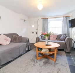A living room with a sofa and coffee table at Willets Cottage in Appledore
