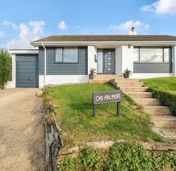 A house with a garage and steps at Chi An Mor Porth