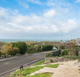 A view of the sea and road with greenery at Chi An Mor in Porth