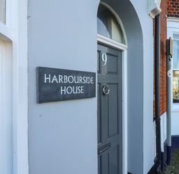 A grey door with number 9 and a Harbourside House sign on a building at Brewers Quay Harbour