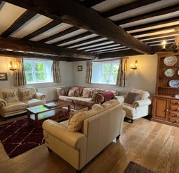 A living room with sofas and a coffee table at Ivy Cottage in West Lulworth