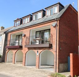 A brick house with balconies and arched carports at Lookout in Cove Castle