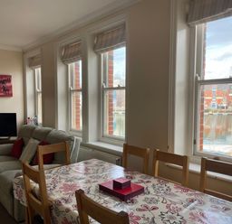 A living room with a sofa and dining table at Mutiny House Brewers Quay Harbour