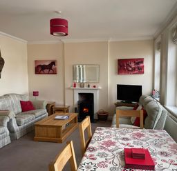 A living room with a sofa and television at Mutiny House in Brewers Quay Harbour