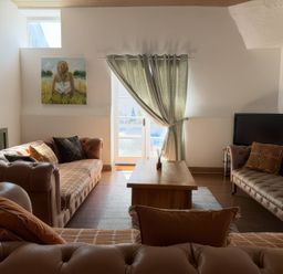 A living room with sofas and a table at The Oast House in Brewers Quay Harbour