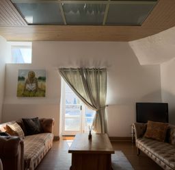 A living room with a sofa and coffee table at The Oast House in Brewers Quay Harbour