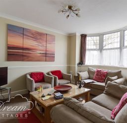 A living room with sofas armchairs a coffee table and a TV at Redcliff View Lodge in Weymouth