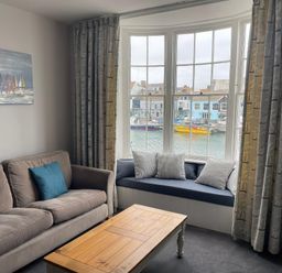 A living room with a sofa and coffee table at Safe Harbour in Brewers Quay harbour