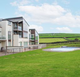 A view of buildings and a swimming pool in the outdoor area at 2 Ocean's Edge Thurlestone