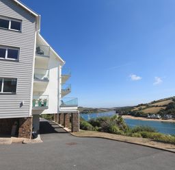A building with balconies overlooking a river and hills at 2 Poundstone Court in Salcombe