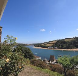 A river with boats and a beach with hills in the background at 2 Poundstone Court in Salcombe