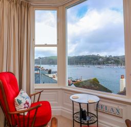 A living room with a window view of the lake and boats at 3 Dartview Dartmouth