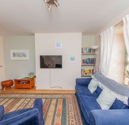 A living room with a sofa and television at 7 Charles Street Dartmouth