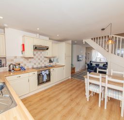 A kitchen with dining area and stairs at 7 Charles Street Dartmouth