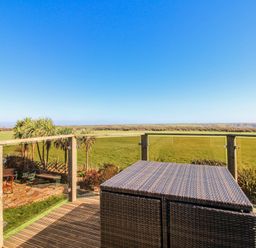 An outdoor area with a table and views of a field at The Station in Bolberry