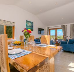 A dining room with a table and chairs at Mellydonen Beder Del (Melly), Tor Down Quarry, St Breward