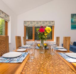 A dining room with a table set for meals at Mellydonen Beder Del (Melly), Tor Down Quarry, St Breward