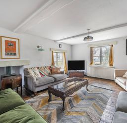 A living room with a coffee table and television at Spring Park Farmhouse Launceston