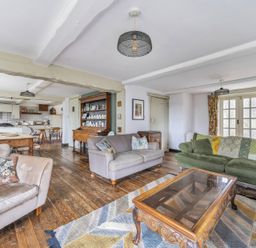 A living room with sofas, a coffee table and a dining table at Spring Park Farmhouse in Launceston