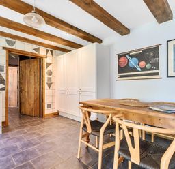 A kitchen with a table and chairs at Woodcutters in Rezare near Launceston