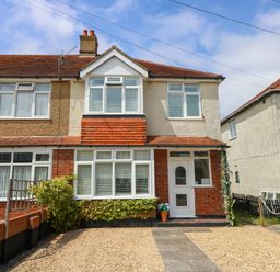 A house with gravel driveway and plants at 32 Cranleigh Close Tuckton