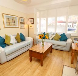 A living room with a coffee table and sofas at 32 Cranleigh Close Tuckton