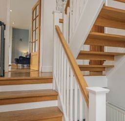 A staircase and door in a hallway at Langtree in Arnside