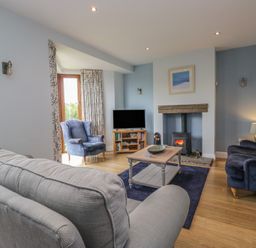 A living room with a television and fireplace at Langtree in Arnside