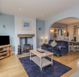A living room with a tv and sofa at Langtree in Arnside