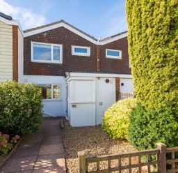 Front exterior of a two story house with a garden path and bushes at 164 Cumber Close in Malborough