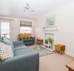 A living room with seating and a fireplace at 17 Fewster Way in York