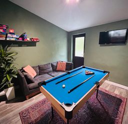 A game room with a pool table and a sofa at Stiniog Lodge in Blaenau Ffestiniog