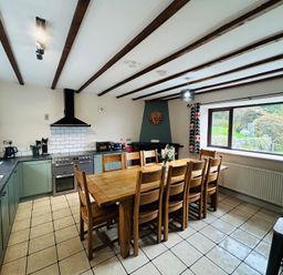 A kitchen with a dining table and chairs at Stiniog Lodge in Blaenau Ffestiniog