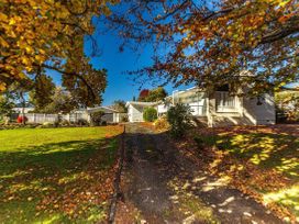 A house with driveway and trees at Kune Crib - Ohakune Holiday Home near Turoa in Ohakune
