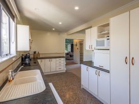 A kitchen with a sink and cabinets at Kune Crib - Ohakune Holiday Home near Turoa