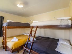 A bedroom with bunk beds and linens at Kune Crib - Ohakune Holiday Home near Turoa