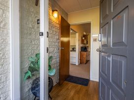 An entryway with a door and a plant at Kune Crib - Ohakune Holiday Home near Turoa
