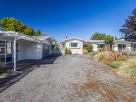 An outdoor view of a house with a gravel driveway at Kune Crib - Ohakune Holiday Home near Turoa
