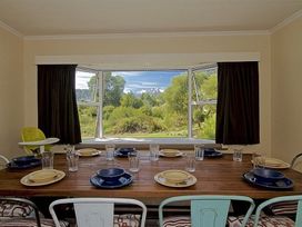 A dining room with a table set for meals at Kune Crib - Ohakune Holiday Home near Turoa Ohakune