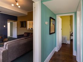 A living room with a sofa and a door at Oroua Cottage - Rangataua Bach in Ohakune