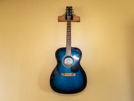 A guitar hanging on a wall at Oroua Cottage - Rangataua Bach Ohakune