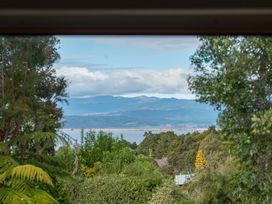 A view of mountains and lake through trees at Pukawa Haven - Pukawa Bay
