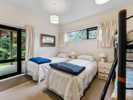 A bedroom with two beds and a bunk bed at Pukawa Haven - Pukawa Bay