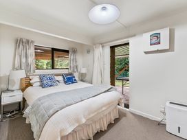 A bedroom with a bed and bedside lamp at Pukawa Haven - Pukawa Bay